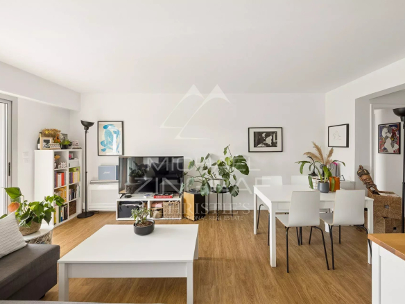 Interior of a modern apartment with living room, dining table and contemporary decor.