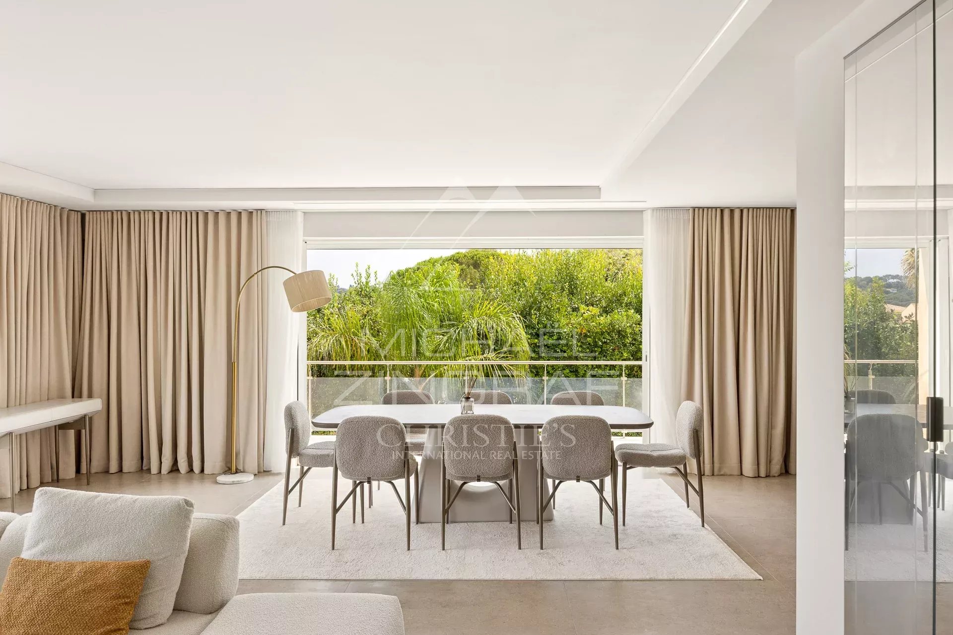 Interior of a contemporary villa with a bright dining room and views of nature.