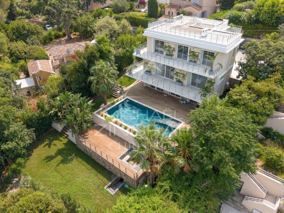 Aerial view of a renovated contemporary villa with swimming pool and garden in Antibes.
