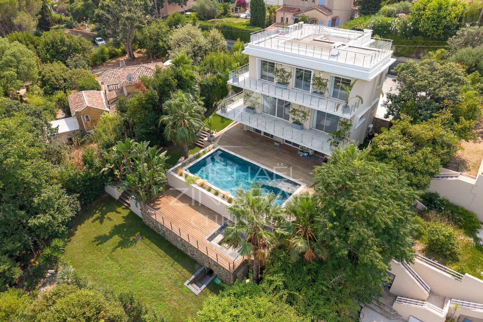 Aerial view of a renovated contemporary villa with swimming pool and garden in Antibes.