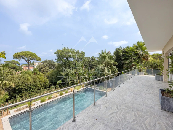 Terrace of a contemporary villa overlooking the pool and garden in Antibes.