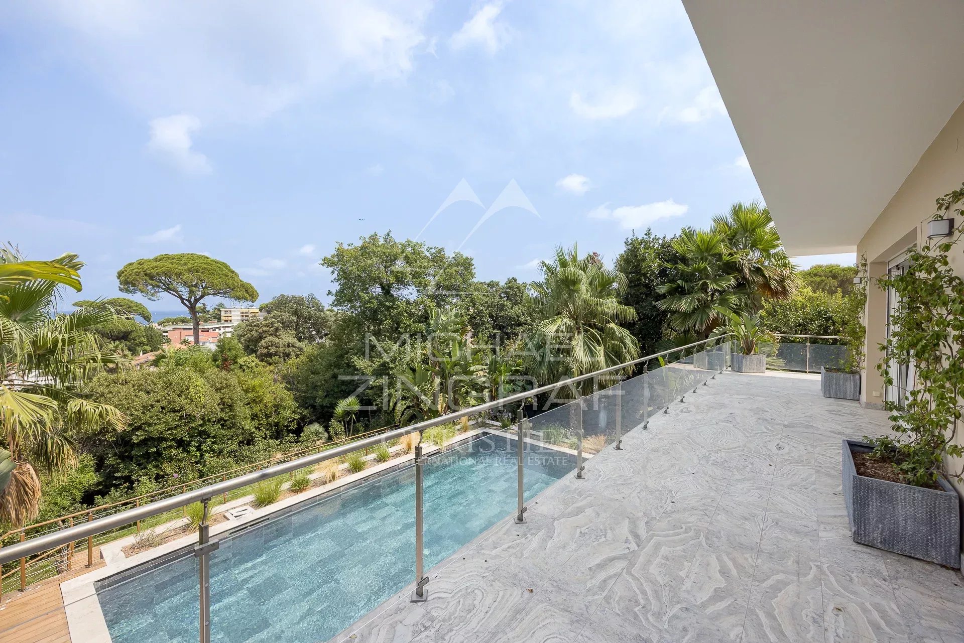 Terrace of a contemporary villa overlooking the pool and garden in Antibes.