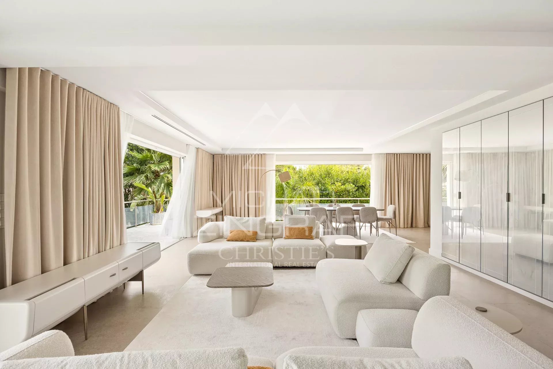 Interior of a renovated contemporary villa with a bright living room and large windows.
