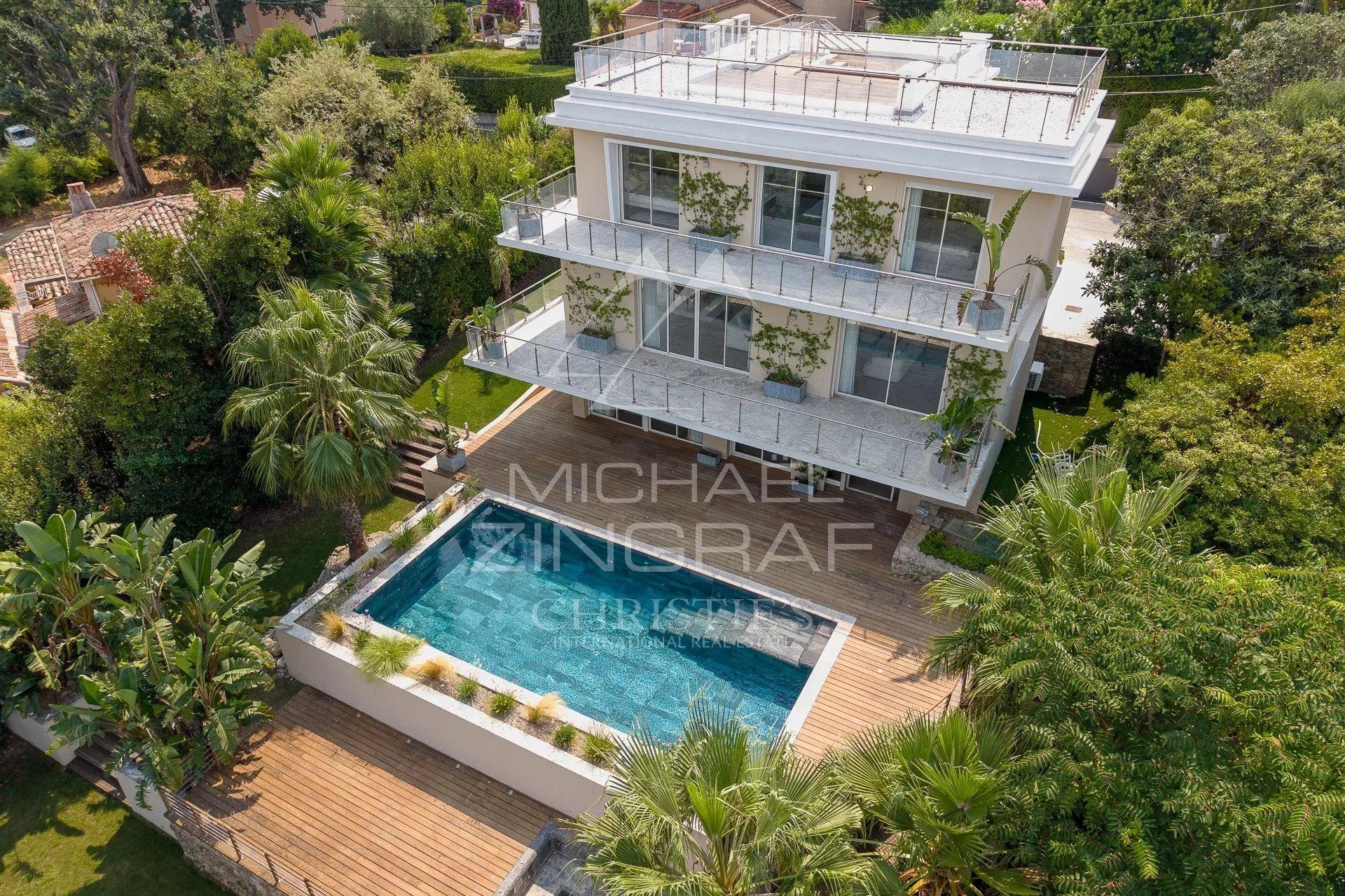 Contemporary renovated villa with swimming pool and garden in Antibes, aerial view.