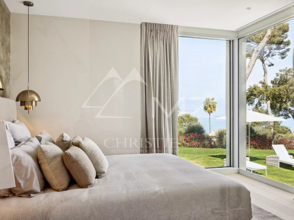Room in a modern villa with sea views in Antibes, large windows and elegant decor.