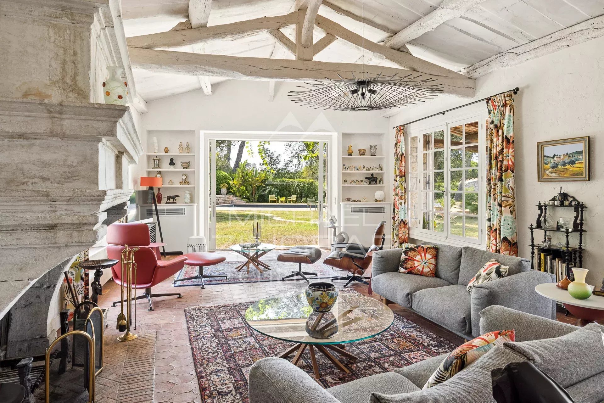 Living room of a Provencal farmhouse in Cap d'Antibes Interior of a Provençal farmhouse with bright living room, fireplace and modern furniture in Cap d'Antibes.