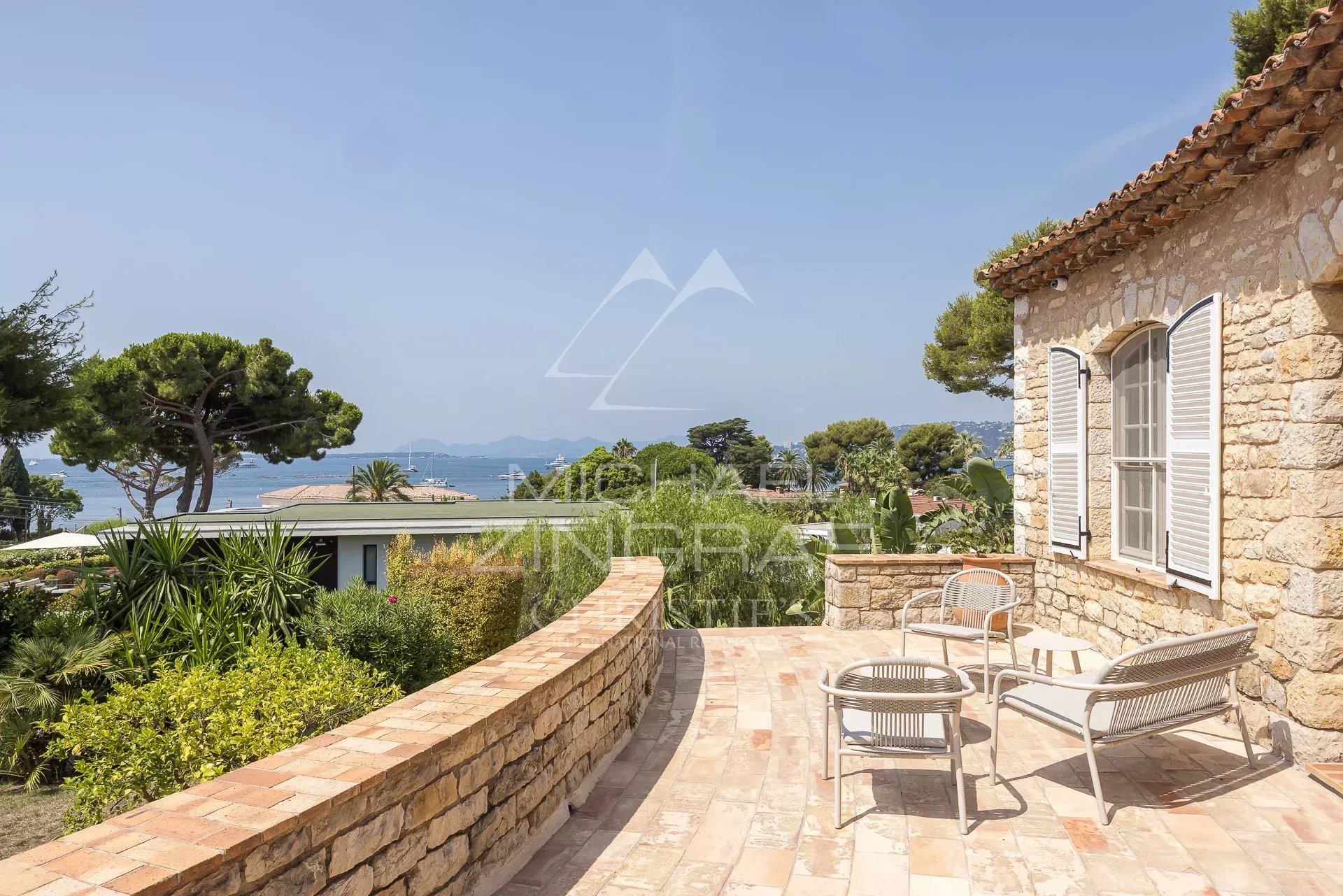 Provençal farmhouse with sea view in Cap d'Antibes Stone terrace of a Provençal farmhouse with sea views at Cap d'Antibes.