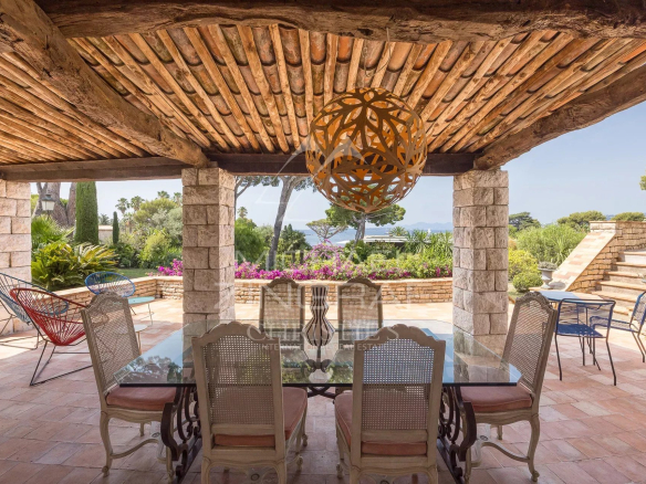 Terrace of a Provençal property with sea views at Cap d'Antibes, elegant furniture.