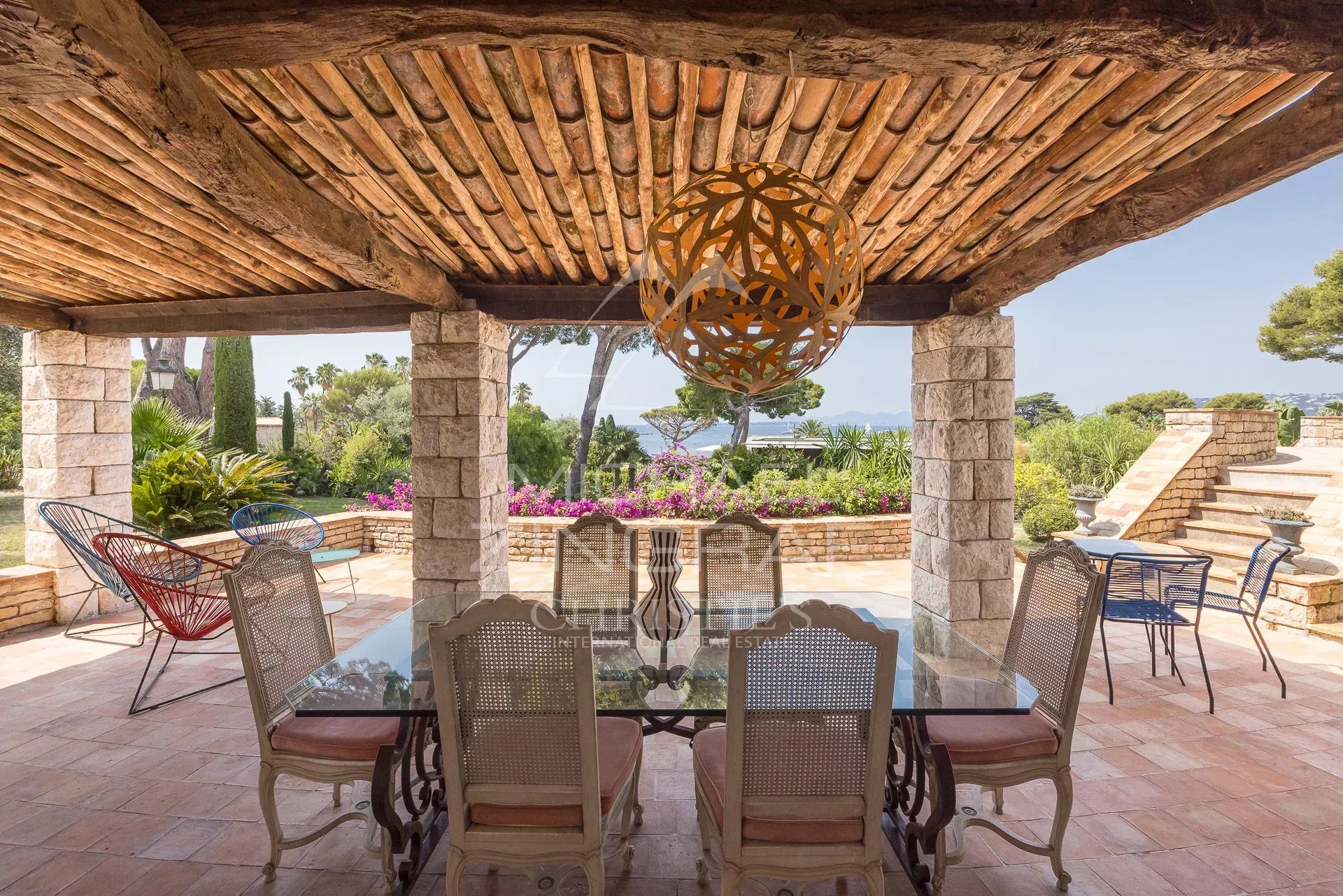 Terrace with sea view at Cap d'Antibes Terrace of a Provençal property with sea views at Cap d'Antibes, elegant furniture.