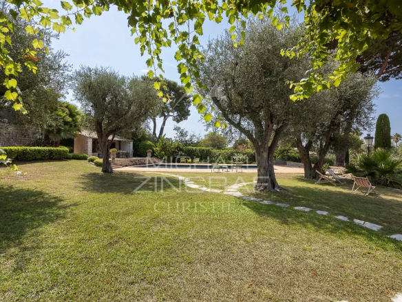 Green garden with olive trees and relaxation area at Cap d'Antibes.
