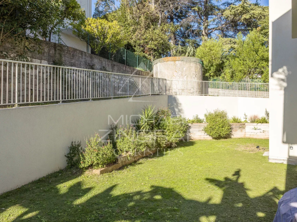 Jardin de 250 m² d'un appartement en rez-de-jardin à Antibes, avec pelouse et aménagement paysager.