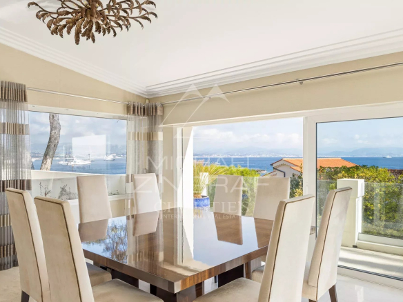 Interior of a villa in Cap d'Antibes with sea view, elegant and bright dining room.