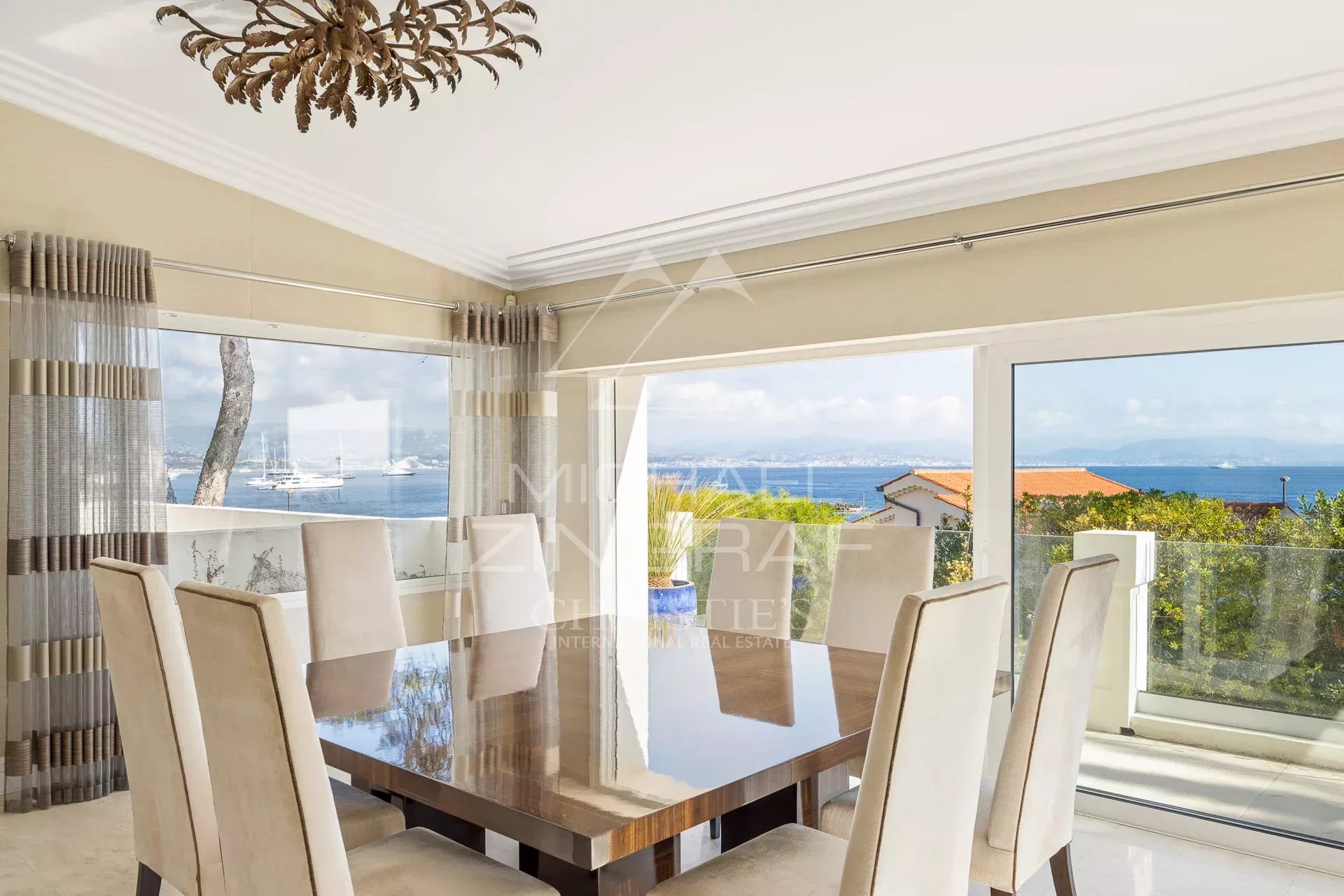Dining room with a view in Cap d'Antibes Interior of a villa in Cap d'Antibes with sea view, elegant and bright dining room.