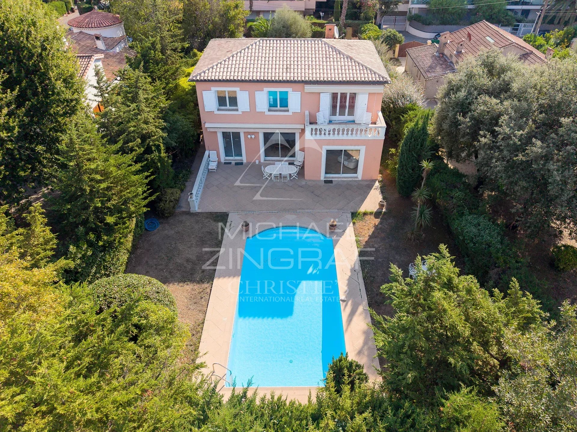 Property with swimming pool in Antibes House with swimming pool surrounded by greenery in Antibes, aerial view.