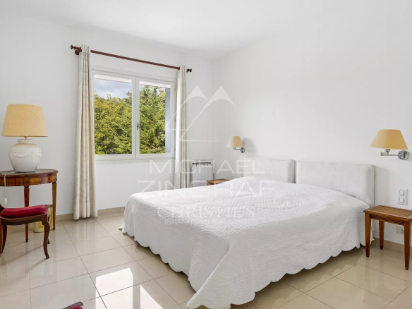 Room in a house in Antibes with a double bed and elegant furniture.