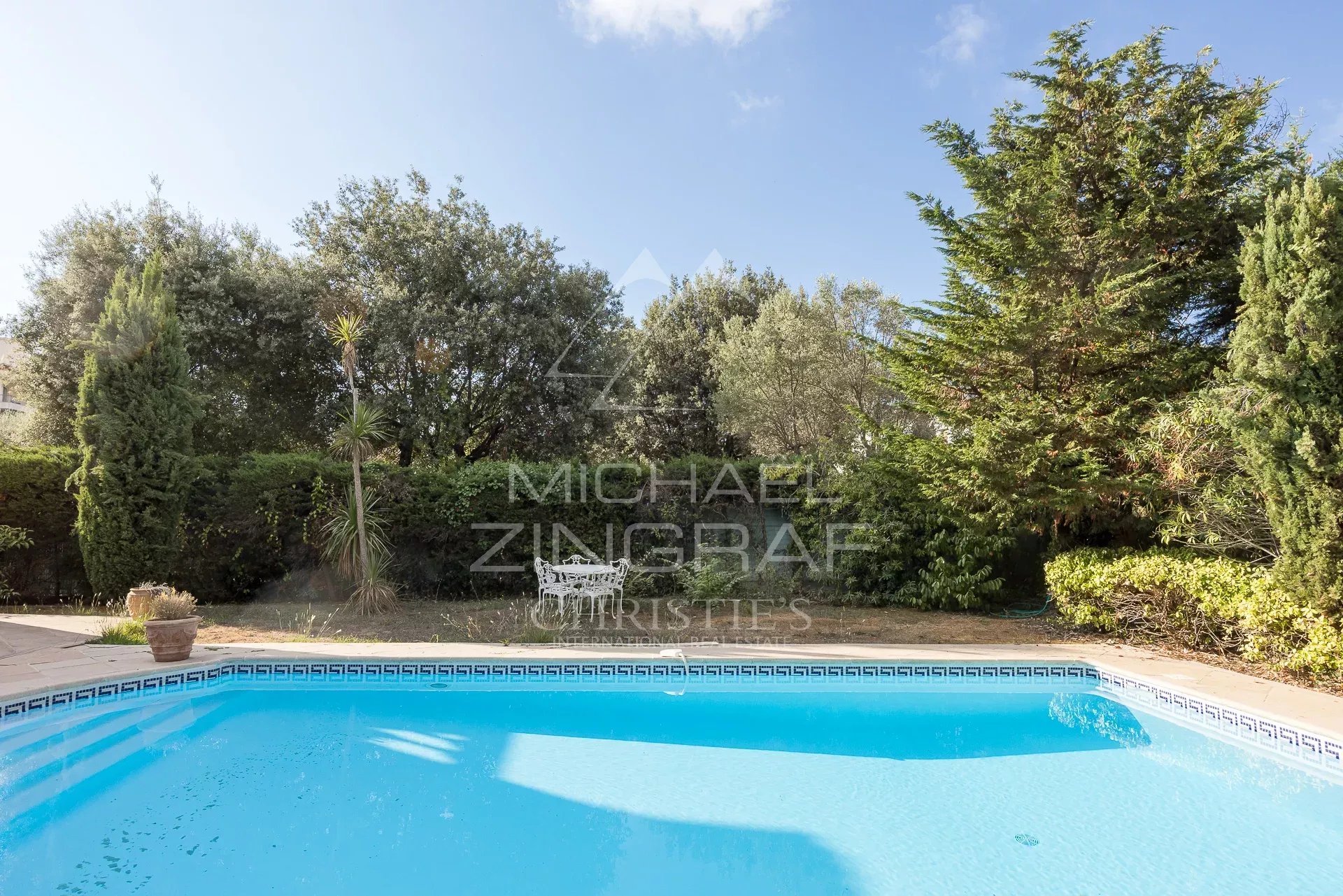 Property with swimming pool in Antibes Swimming pool surrounded by greenery in a property in Antibes.