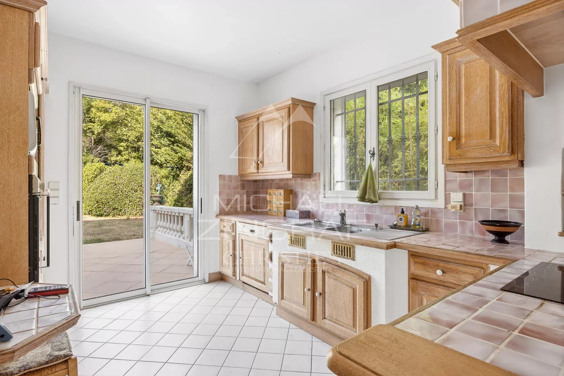 Kitchen of a property in Antibes Bright kitchen with wooden furniture and access to the outside, located in Antibes.