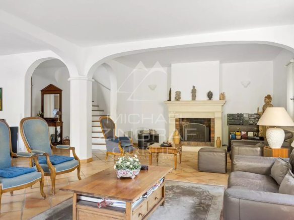 Interior of a house in Antibes with a spacious living room and a fireplace.