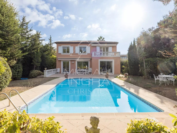 House with swimming pool surrounded by greenery in Antibes, France.