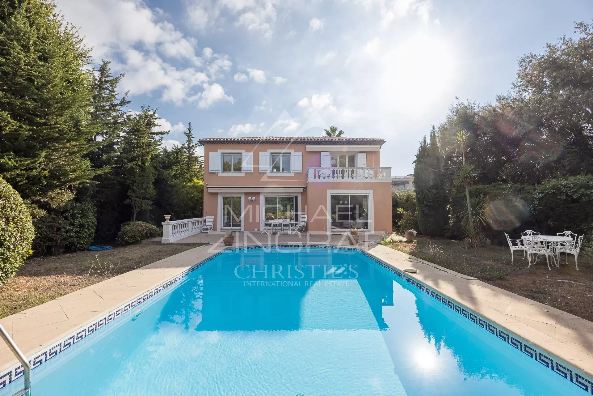 Property in Antibes with swimming pool House with swimming pool and garden in Antibes, surrounded by trees and greenery.