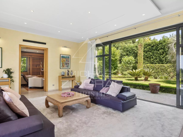 Interior of a contemporary villa with a bright living room and access to the garden.