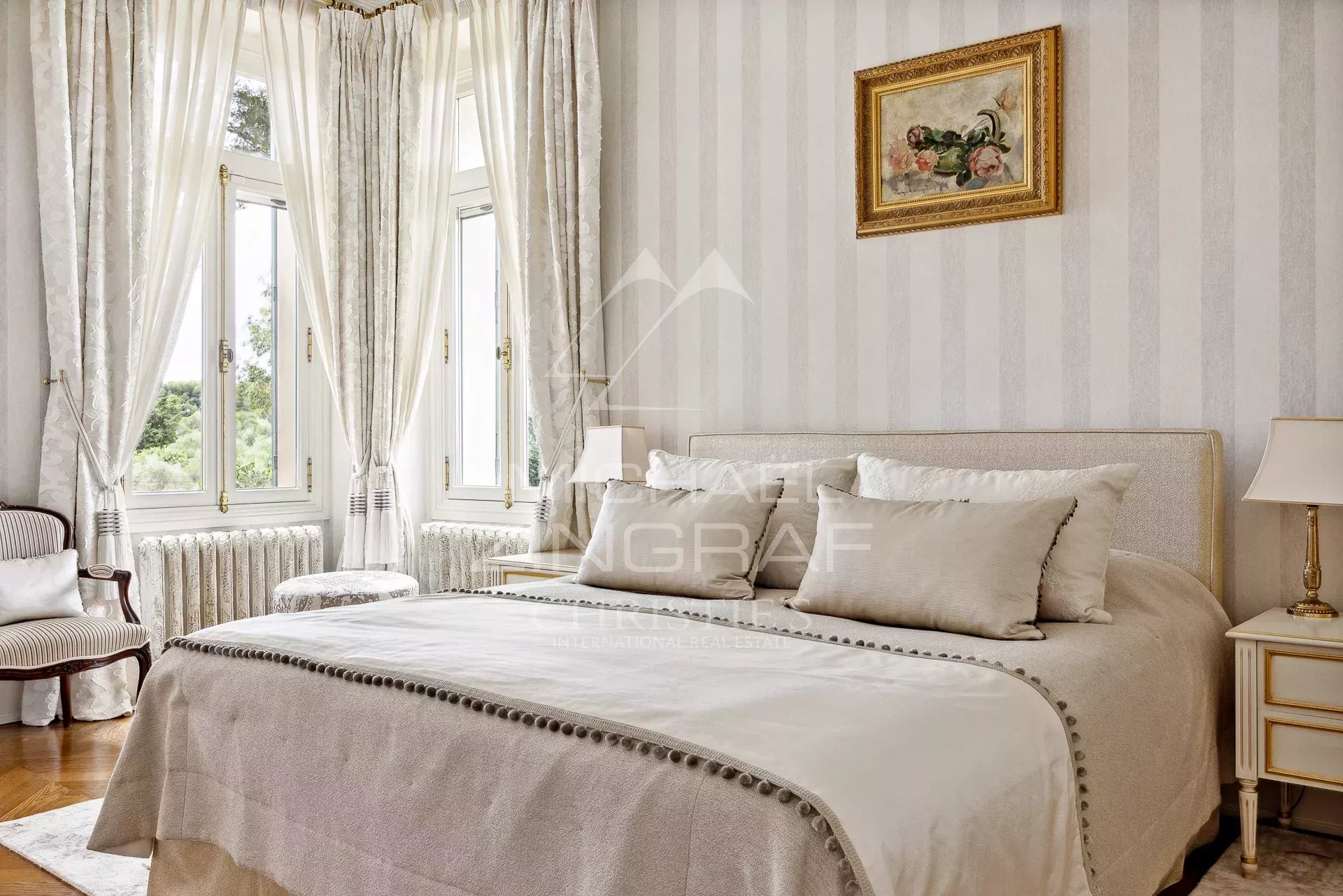 Room in a Belle Époque property with bright windows and elegant decor.
