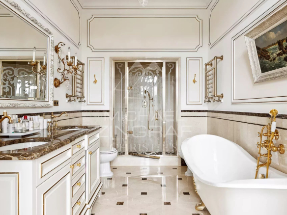 Luxurious bathroom with freestanding bathtub and shower, decorated in an elegant style.