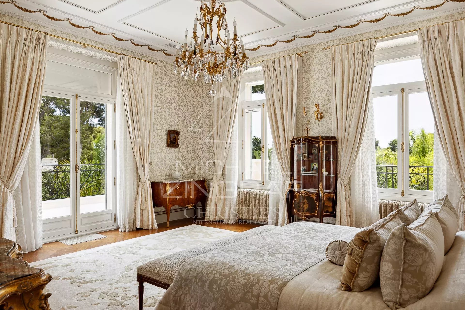 Room in a Belle Époque property with elegant decor and garden view.