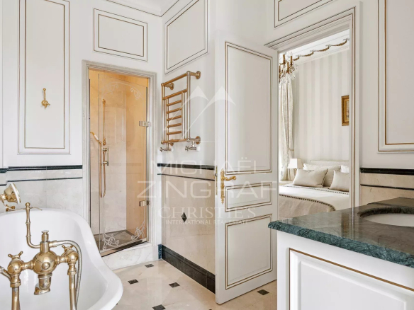 Elegant bathroom with freestanding bathtub and shower, decorated in a Belle Époque style.