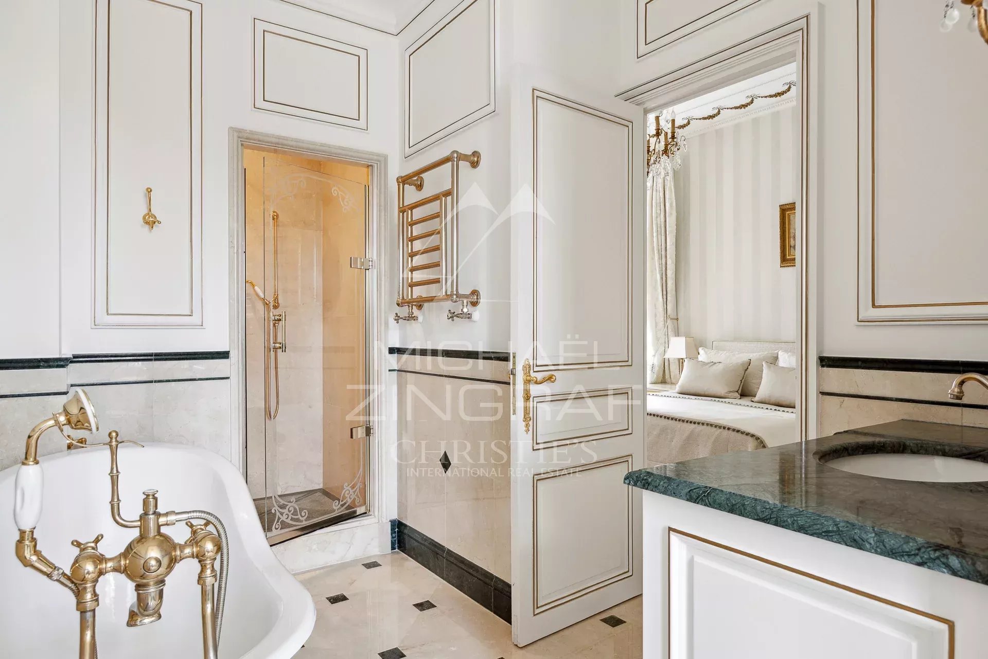 Elegant bathroom with freestanding bathtub and shower, decorated in a Belle Époque style.