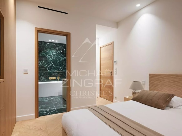 Chambre d'un appartement rénové avec salle de bain, murs clairs et décoration moderne.