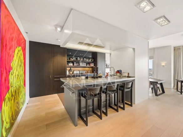 Modern American kitchen with bar and bright living space in a penthouse in Cannes.