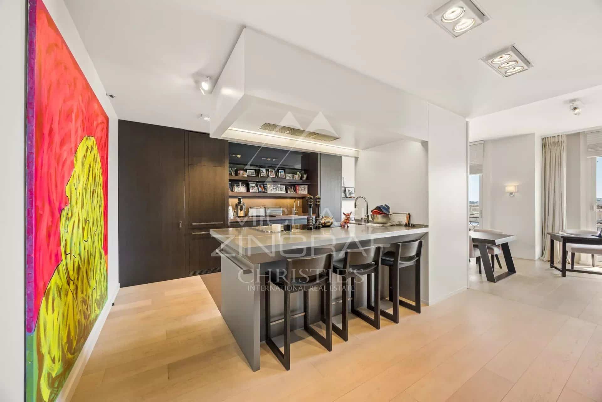 Modern American kitchen with bar and bright living space in a penthouse in Cannes.