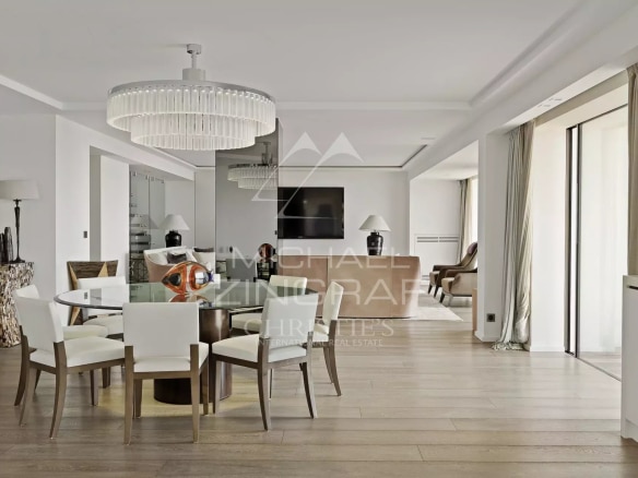 Interior of a modern penthouse with a bright dining room and living room in Cannes.