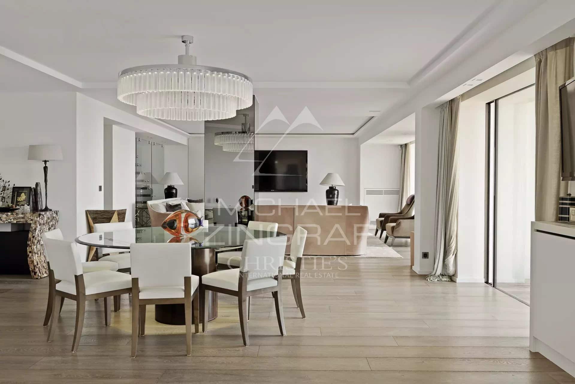Interior of a modern penthouse with a bright dining room and living room in Cannes.