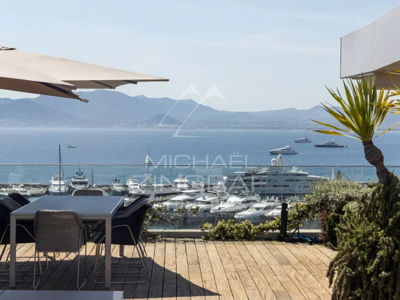 Penthouse with panoramic sea views in Cannes, wooden terrace and outdoor furniture.