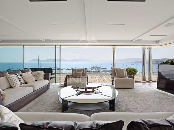 Interior of a penthouse in Cannes with panoramic sea views and modern furnishings.