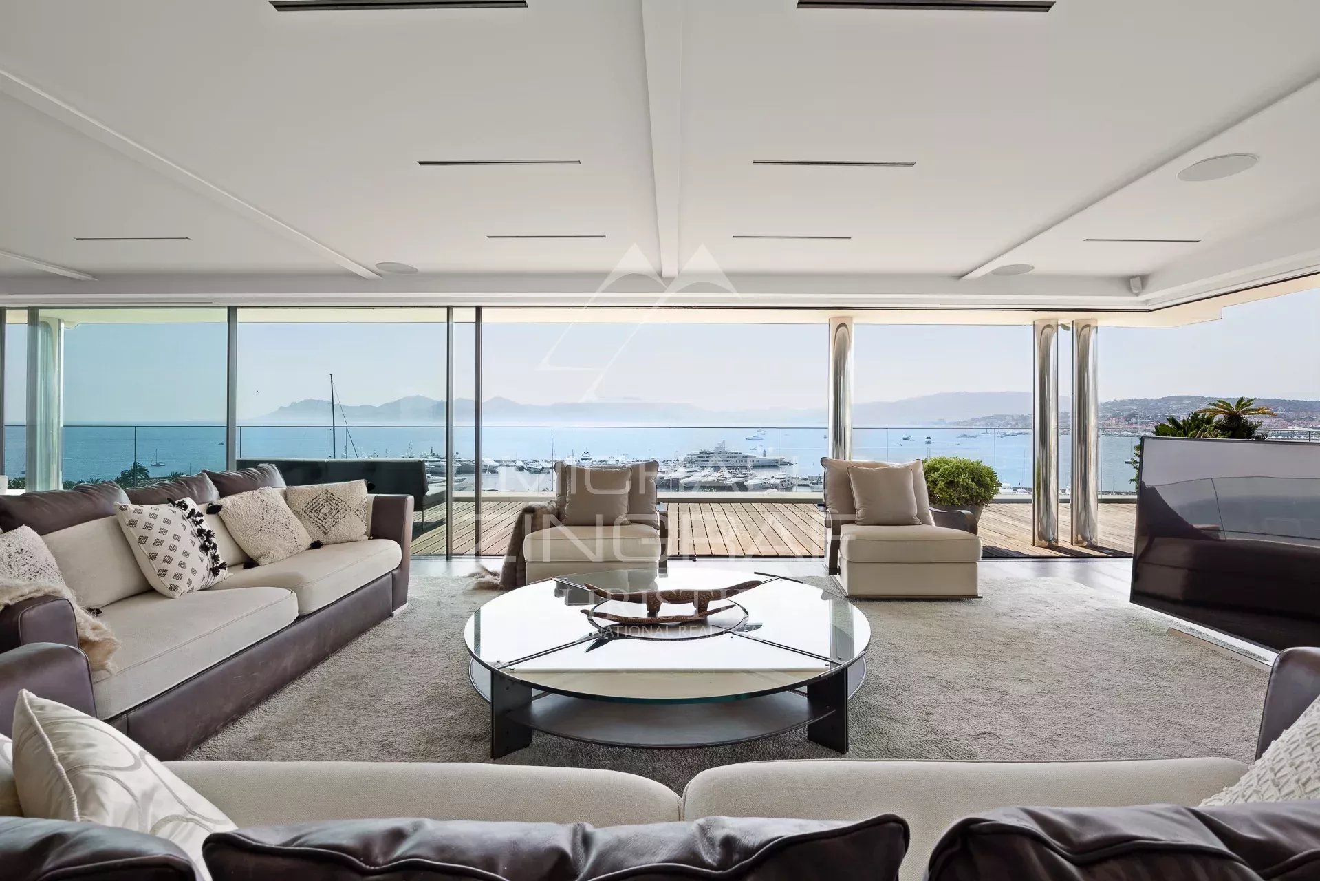Interior of a penthouse in Cannes with panoramic sea views and modern furnishings.