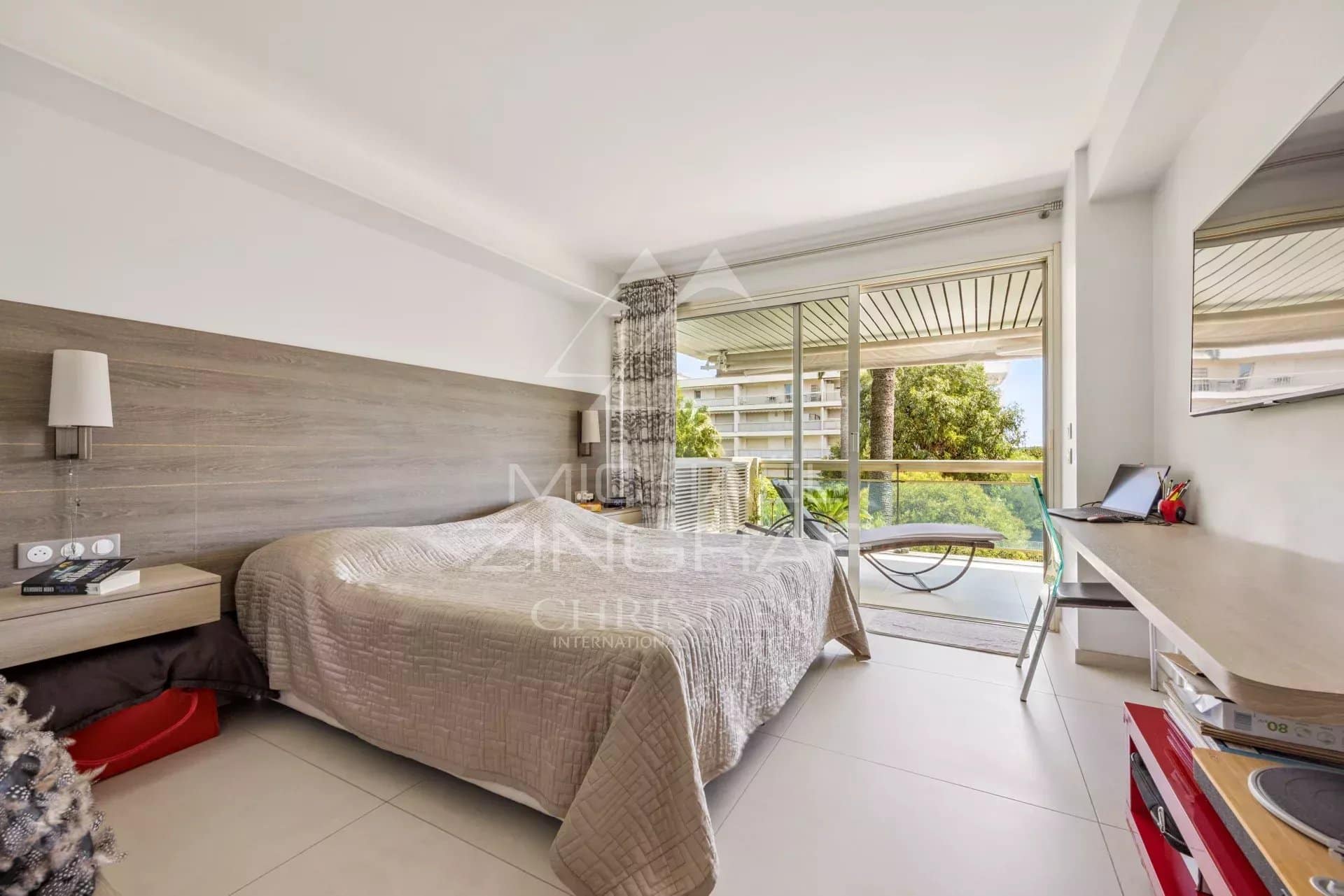 Room in an apartment in Cannes with balcony and view of greenery.