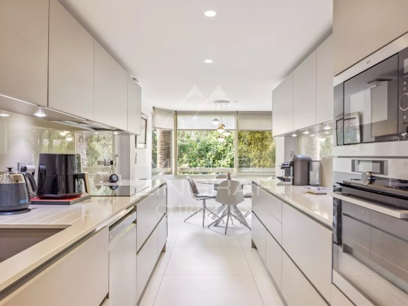 Modern and bright kitchen in an apartment in Cannes, with high-end equipment and dining area.