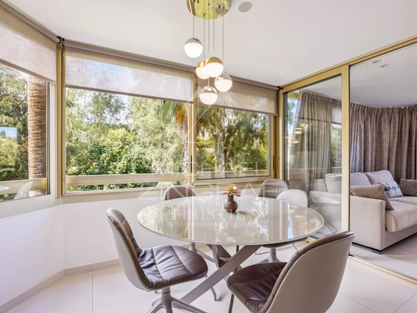 Bright dining room with views of nature, apartment in Cannes Palm Beach.