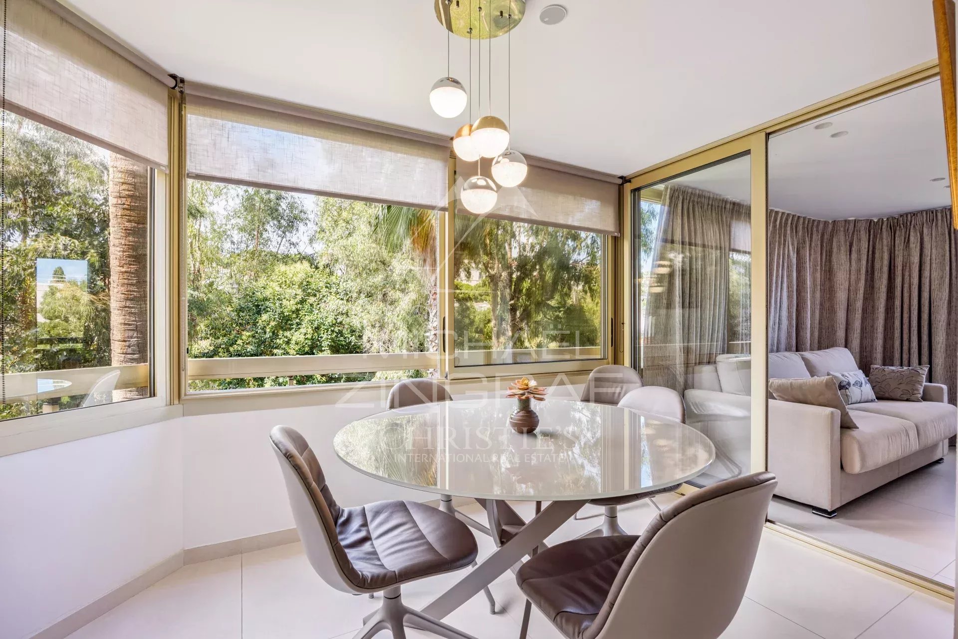 Bright dining room with views of nature, apartment in Cannes Palm Beach.