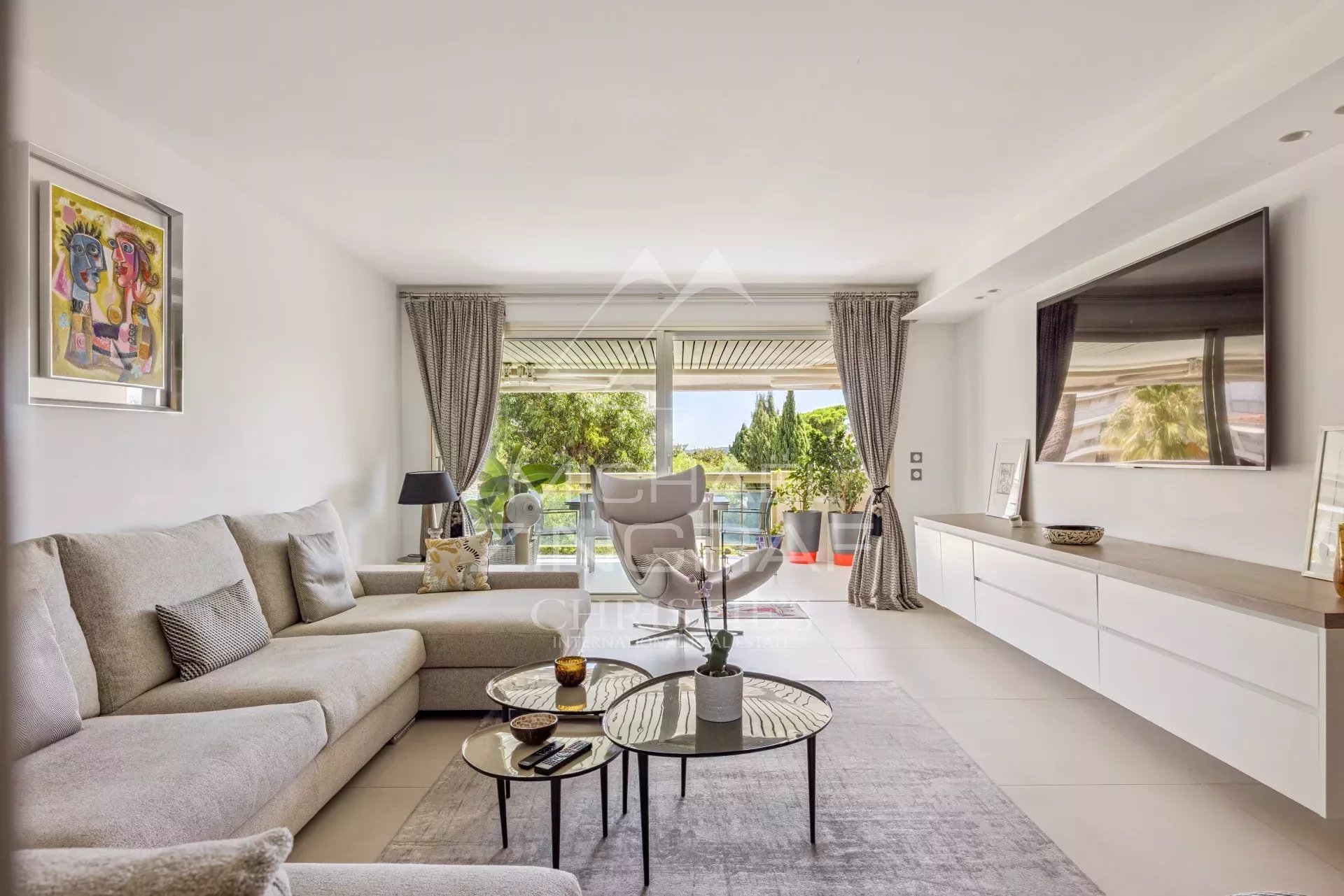 Bright living room of a renovated apartment in Cannes with sea view.