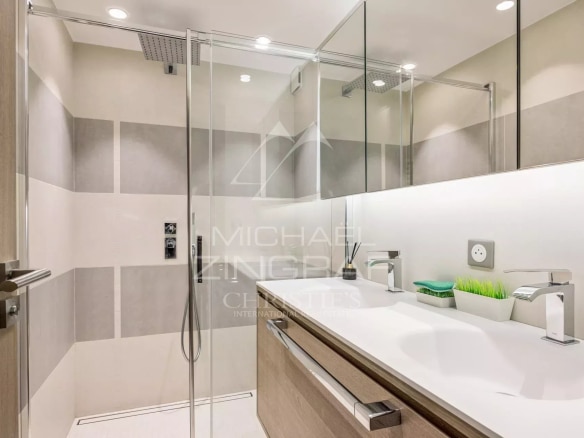 Modern bathroom with walk-in shower and wooden vanity unit.