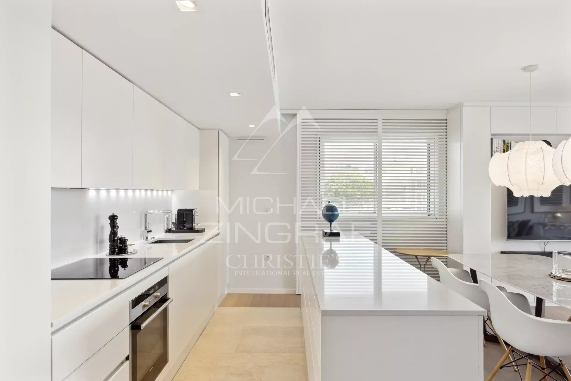 Kitchen of an apartment in Cannes Modern and sleek kitchen in a Cannes apartment, with central island and high-end equipment.