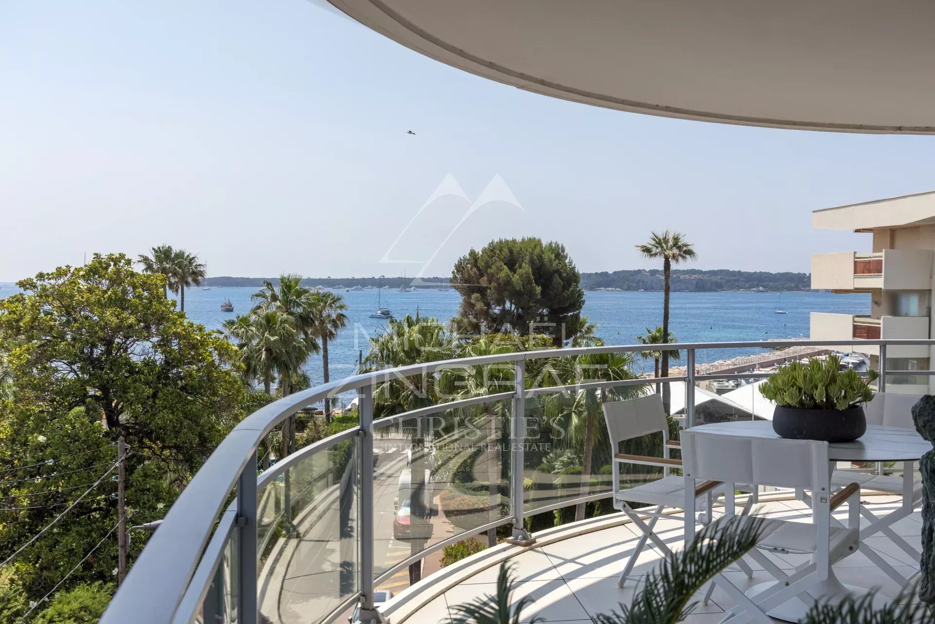 Balcony with sea view in Cannes View from an apartment balcony in Cannes, with sea and palm trees in the background.