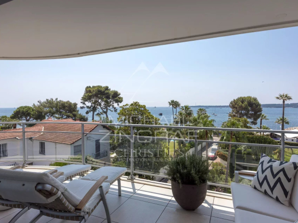 Terrace of an apartment in Cannes with sea view and modern furniture.