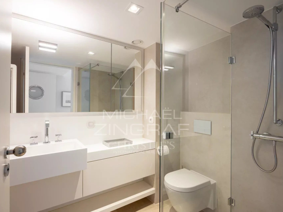 Modern bathroom with shower, sink and toilet in an apartment in Cannes.