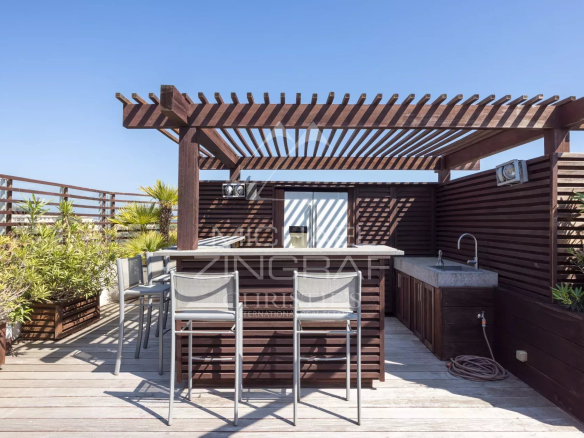 Wooden terrace with bar and chairs, unobstructed view, sunny.