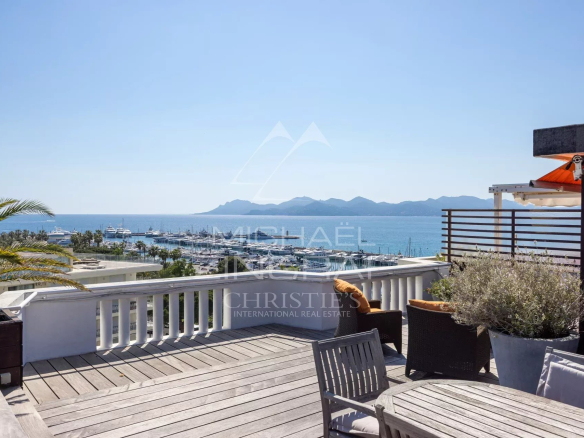 View from a furnished rooftop terrace overlooking the port of Cannes and the sea.